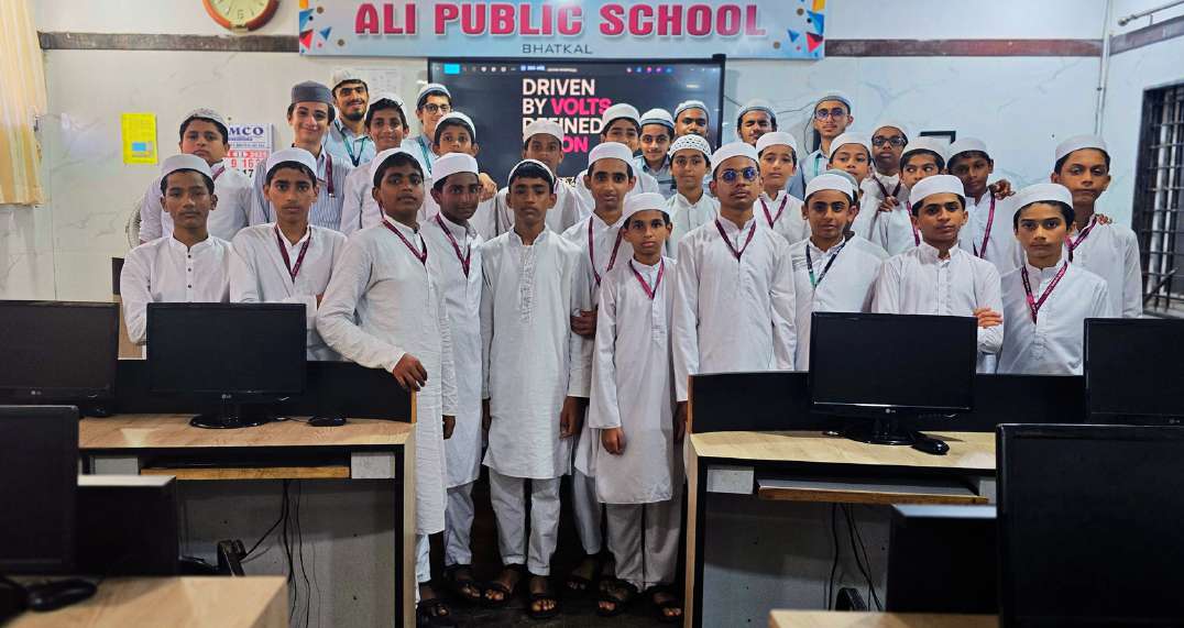 Mohiddin, Zaid, and Omer teaching robotics components and history to Ali Public School students.