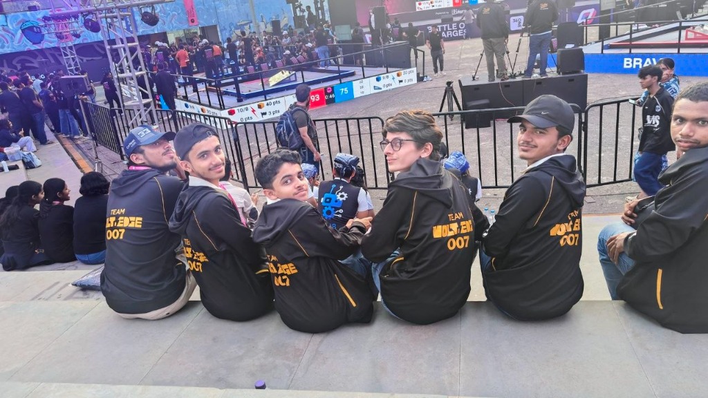 Team VoltEdge members in custom jackets overlooking the arena